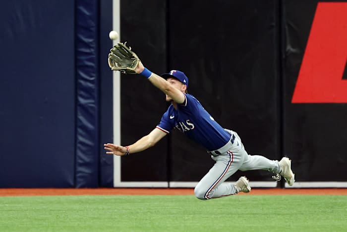 Texas Rangers left fielder Evan Carter catches a fly ball hit by Tampa Bay Rays third baseman Isaac Paredes in the first inning during Game 1 of the AL Wild Card series on Oct. 3 at Tropicana Field.